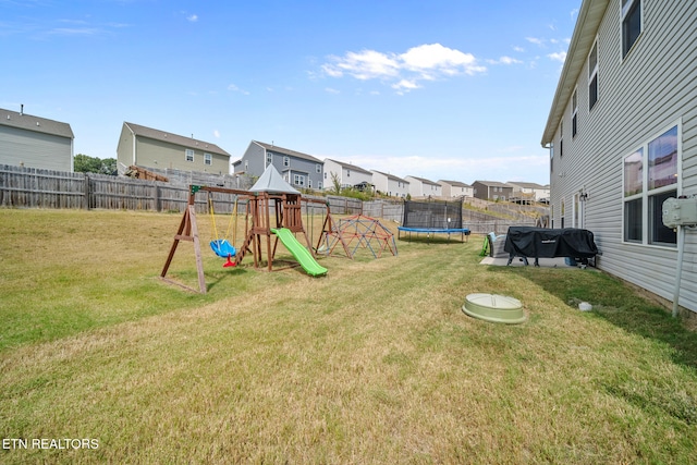 view of yard featuring a playground and a trampoline