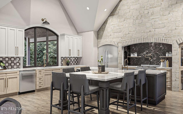 dining area featuring high vaulted ceiling, light hardwood / wood-style flooring, and sink