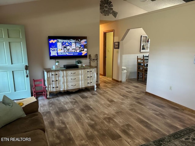 living room with wood-type flooring and ceiling fan