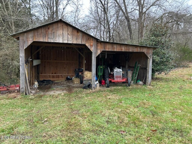 view of outbuilding featuring a yard