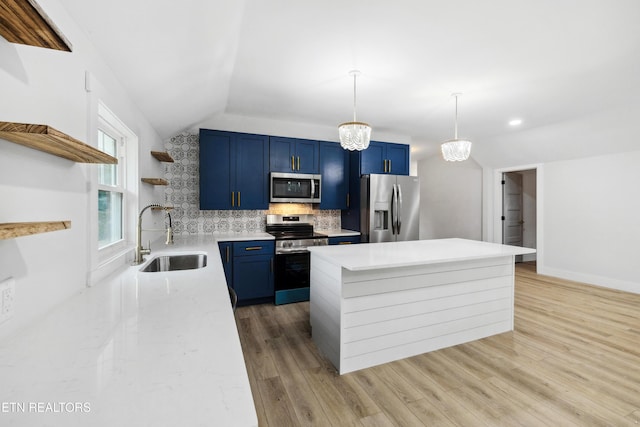 kitchen featuring sink, blue cabinets, lofted ceiling, and appliances with stainless steel finishes