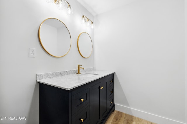 bathroom featuring hardwood / wood-style flooring and vanity