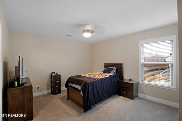 bedroom featuring light colored carpet and ceiling fan