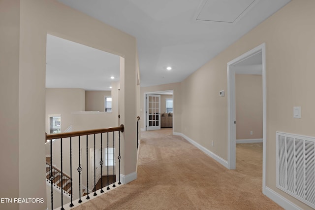 corridor featuring recessed lighting, light colored carpet, an upstairs landing, visible vents, and baseboards