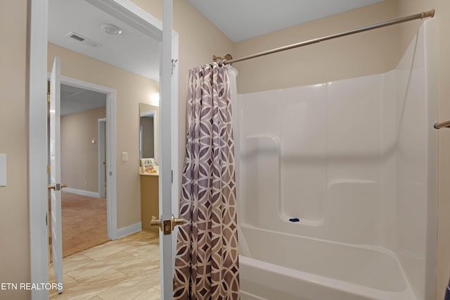 bathroom with shower / tub combo with curtain and tile patterned flooring