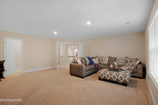 carpeted living room with french doors