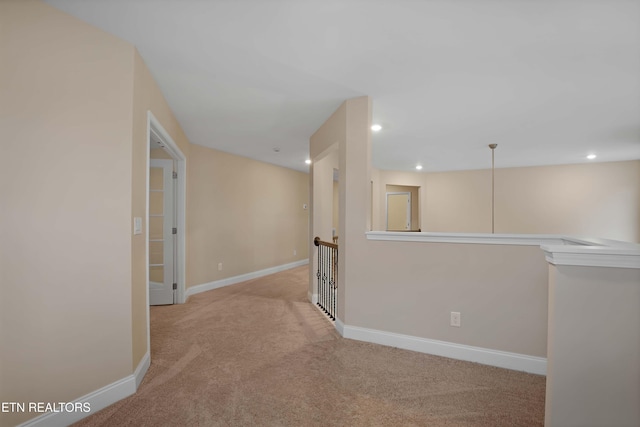 corridor with an upstairs landing, recessed lighting, baseboards, and light colored carpet