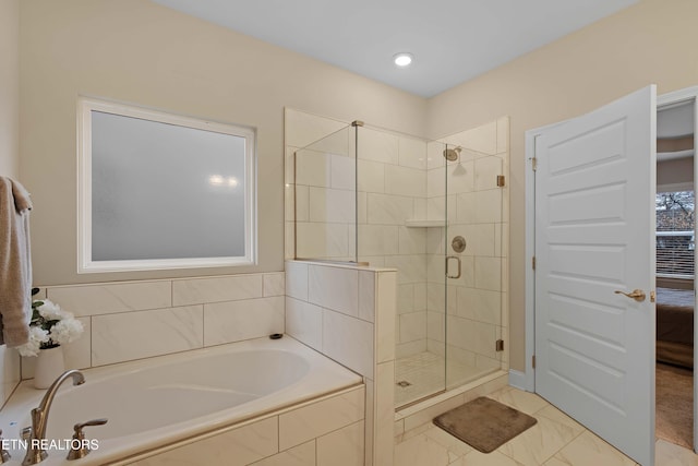 ensuite bathroom with a garden tub, a shower stall, and connected bathroom