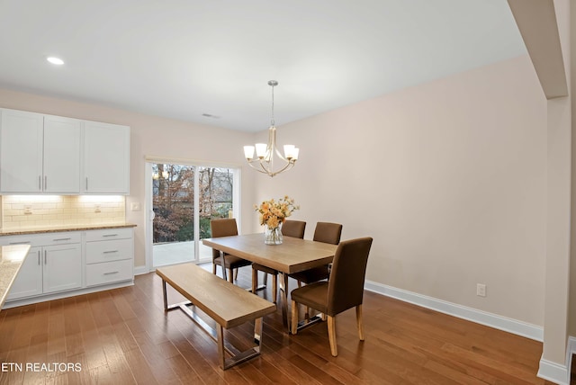 dining room featuring recessed lighting, visible vents, an inviting chandelier, wood finished floors, and baseboards