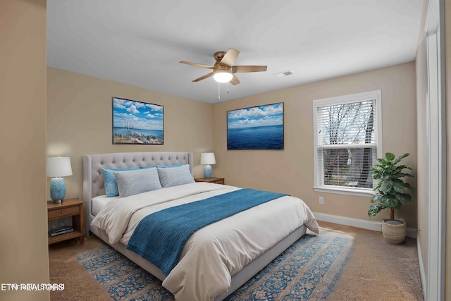 carpeted bedroom featuring a ceiling fan, visible vents, and baseboards