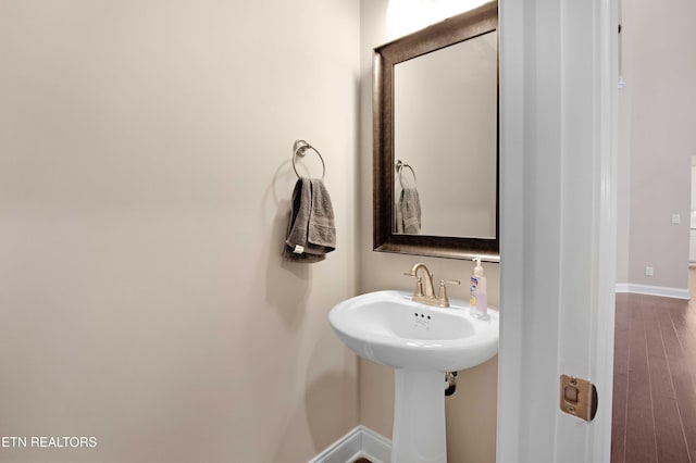 bathroom featuring baseboards and wood finished floors