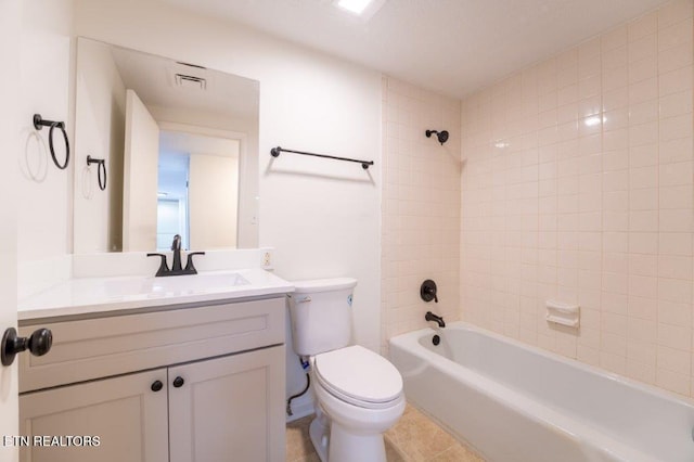 full bathroom with toilet, tiled shower / bath, and vanity