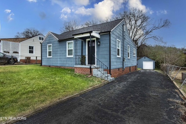 view of front of property with an outbuilding, a garage, and a front yard