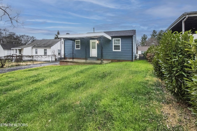 rear view of property with a yard