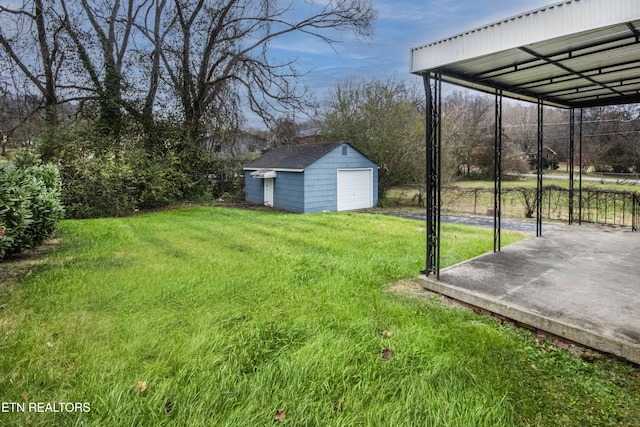 view of yard with an outbuilding, a carport, and a garage