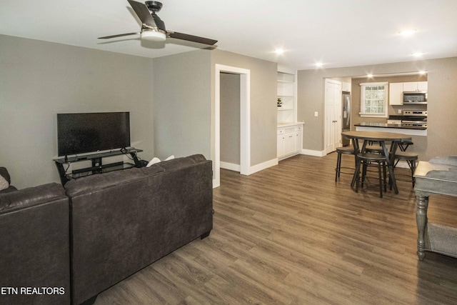 living room featuring dark hardwood / wood-style floors and ceiling fan