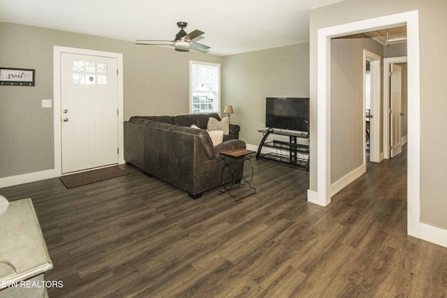 living room featuring dark hardwood / wood-style flooring and ceiling fan