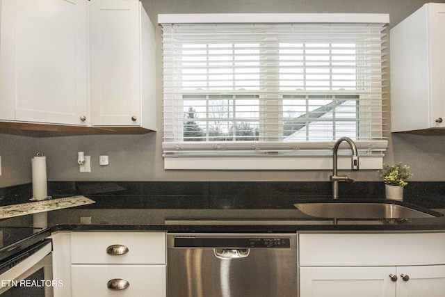 kitchen with stainless steel dishwasher, wall oven, white cabinets, and sink