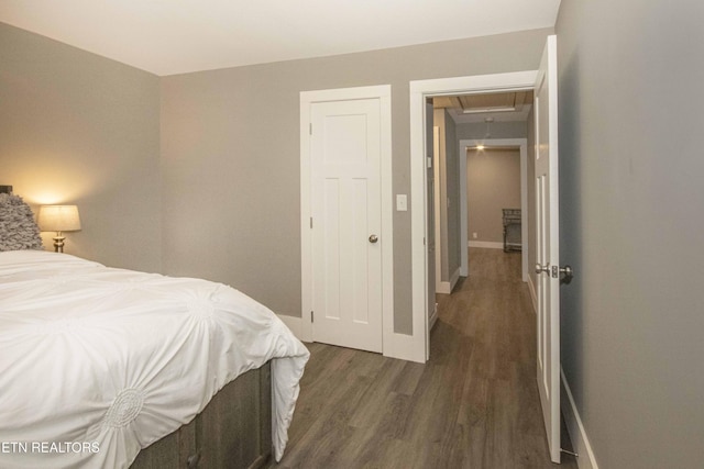 bedroom featuring a closet and dark wood-type flooring