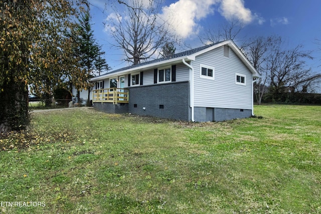 view of property exterior featuring a lawn and a wooden deck