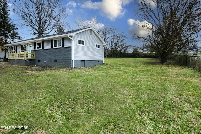 view of property exterior featuring a lawn and a wooden deck