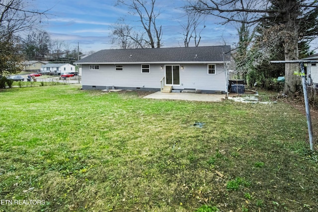 back of property with a yard and a patio area