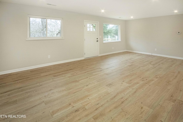 empty room with light hardwood / wood-style floors