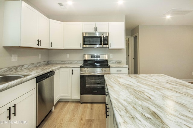 kitchen with white cabinetry and stainless steel appliances