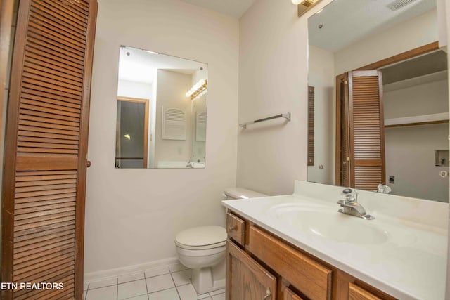 bathroom with tile patterned floors, vanity, and toilet