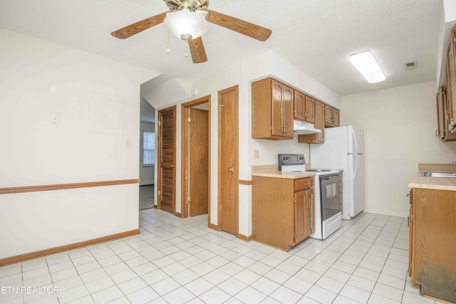 kitchen with a textured ceiling, white appliances, ceiling fan, and sink