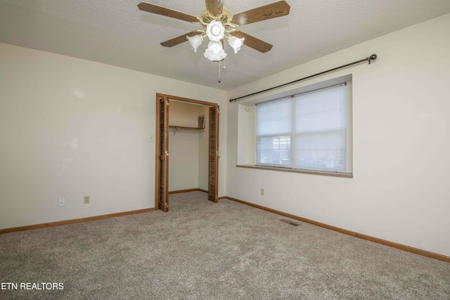 unfurnished bedroom with carpet flooring, a closet, and ceiling fan