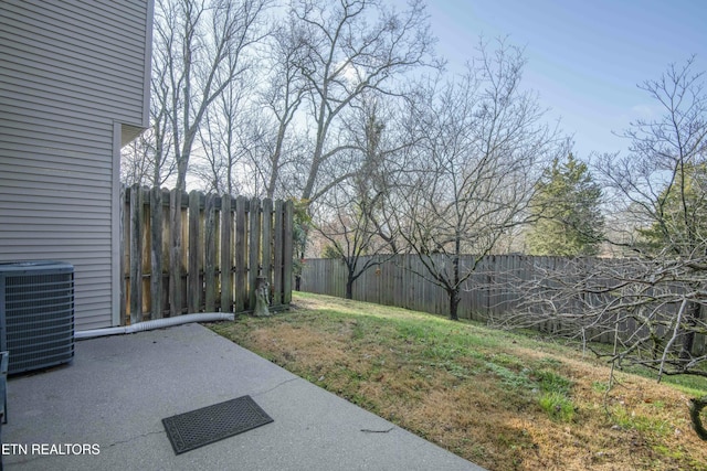 view of yard with central AC unit and a patio area