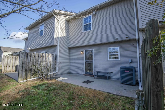 back of house with a yard, a patio, and central AC unit