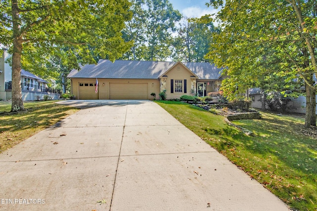 ranch-style home with a front yard and a garage