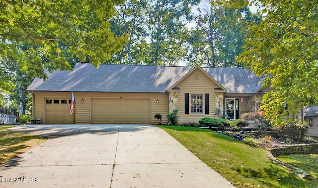 ranch-style home featuring a garage and a front lawn