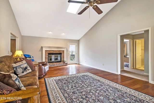 living room featuring a fireplace, ceiling fan, dark hardwood / wood-style flooring, and lofted ceiling