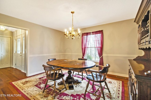 dining space with dark hardwood / wood-style flooring and a notable chandelier