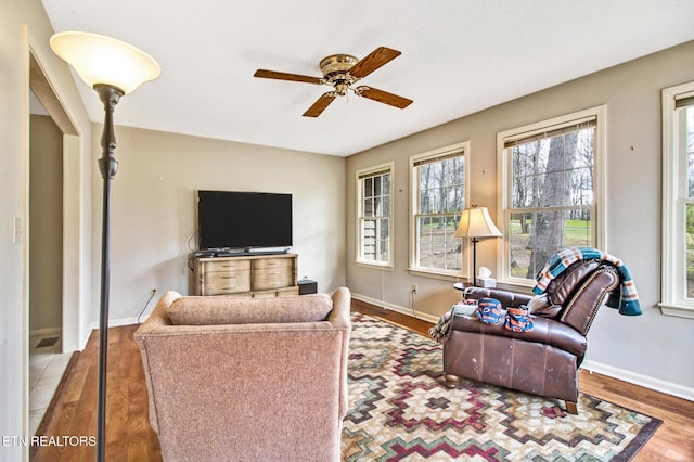 living room with hardwood / wood-style floors and ceiling fan