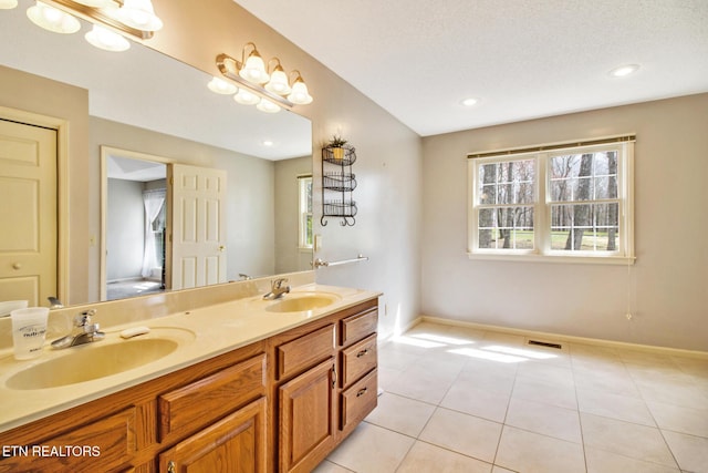 bathroom featuring tile patterned flooring, a textured ceiling, and vanity