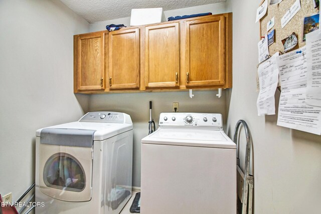 laundry room with separate washer and dryer, cabinets, and a textured ceiling