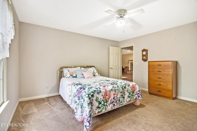 bedroom featuring ceiling fan and carpet