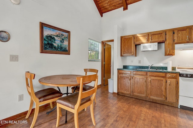 kitchen featuring wooden ceiling, dark wood-type flooring, high vaulted ceiling, sink, and beamed ceiling