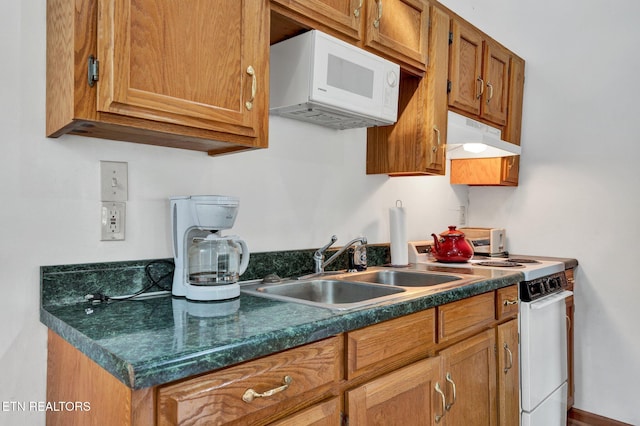 kitchen featuring white appliances and sink