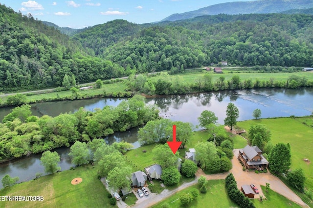 drone / aerial view featuring a water and mountain view