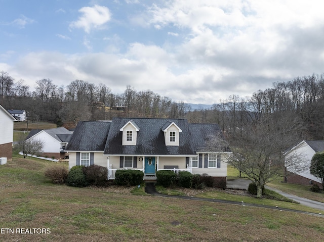 cape cod house with covered porch and a front yard