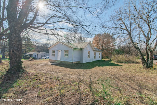 view of property exterior with a lawn