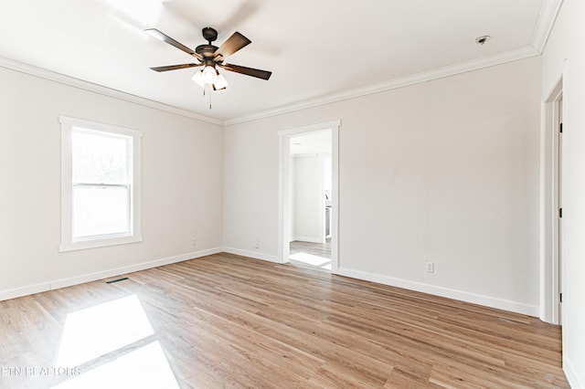 spare room with ceiling fan, light wood-type flooring, and crown molding