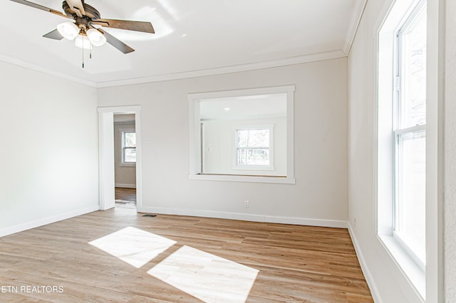 spare room featuring ceiling fan, light wood-type flooring, and ornamental molding