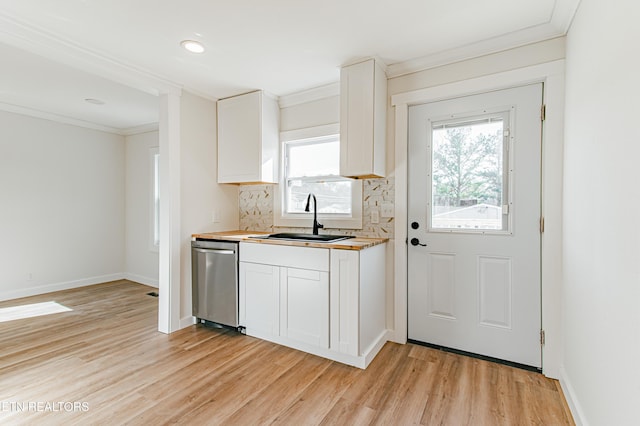 kitchen featuring white cabinets, tasteful backsplash, stainless steel dishwasher, and sink