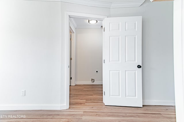 interior space with light hardwood / wood-style flooring and ornamental molding